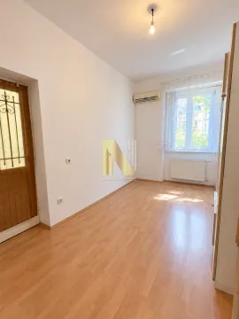 Empty room with laminate flooring, air conditioning unit, and a window. - image 3