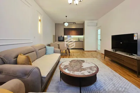 Living room with sofa and TV, connected to the dining area and kitchen. - image 15