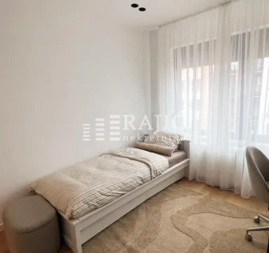 Bright bedroom with a bed and a window covered with curtains. - image 12