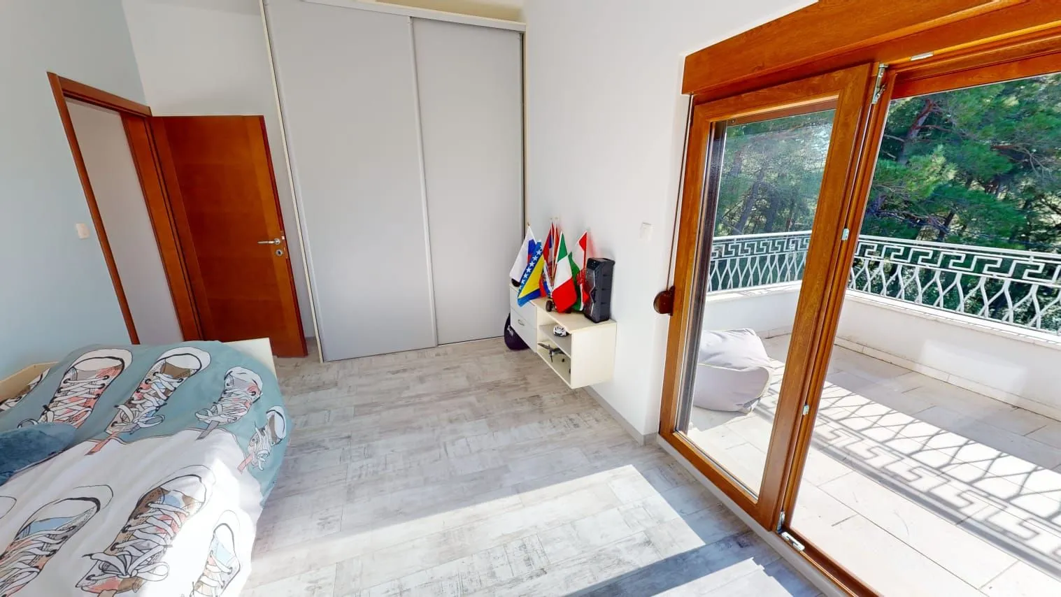 Bedroom with a double bed, wardrobe, and terrace access.
