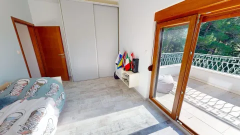 Bedroom with a double bed, wardrobe, and terrace access. - image 18