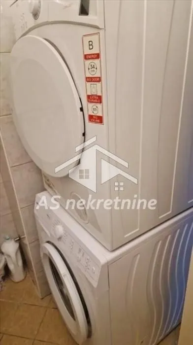 Washing machine and tumble dryer stacked on top of each other.