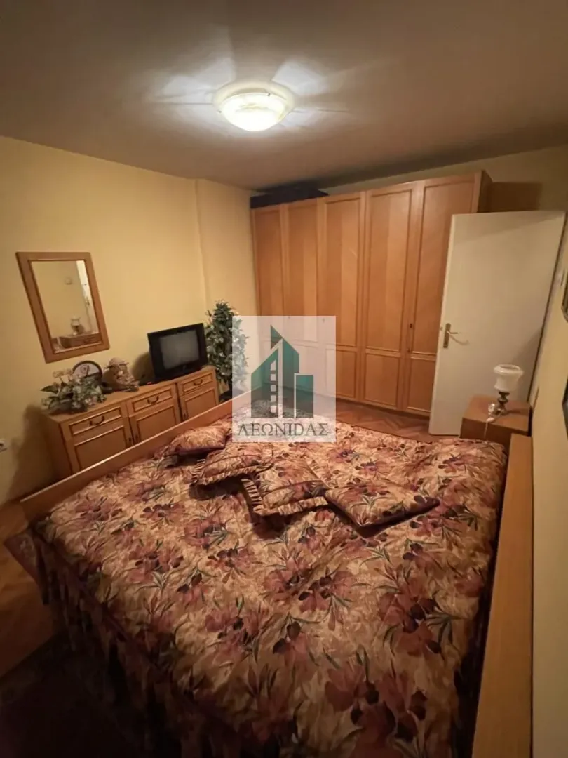 Furnished bedroom with a double bed, wardrobe, and chest of drawers.