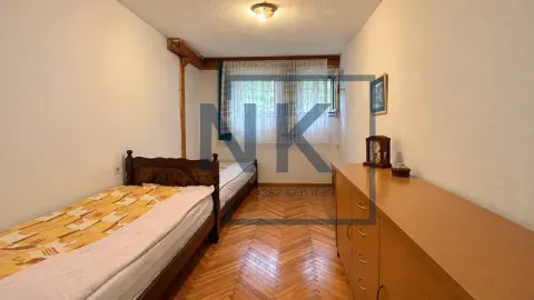Bedroom with two single beds and wooden parquet flooring. - image 2