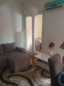 Living room with a corner sofa, carpet, and a view into the adjacent room. - image 16