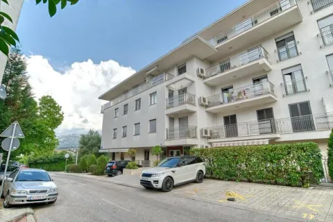View of the exterior of the residential building and parking in front of the entrance. - image 22