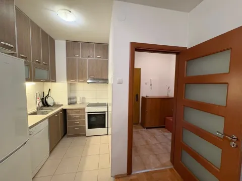 Kuhinja sa drvenim elementima, sudoperom i šporetom. - image 4