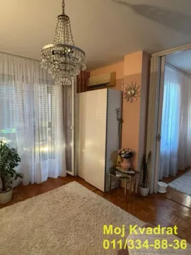 Living room with parquet flooring, a chandelier, and balcony access. - image 4