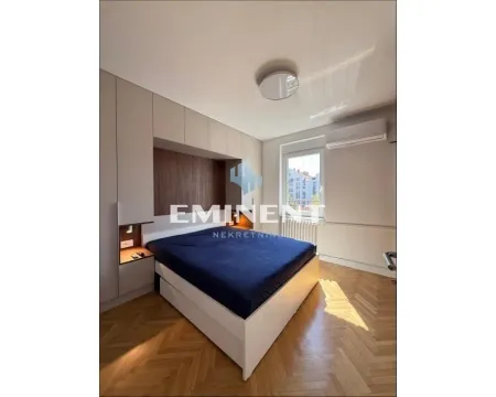 Bedroom with a double bed and built-in wardrobes. - image 11