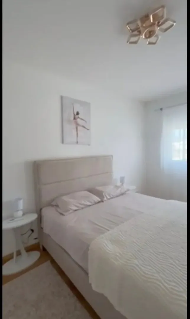 Bright and tidy bedroom with a double bed.