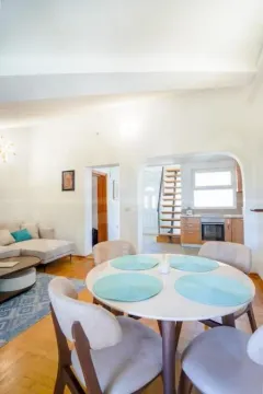 Living room with a dining area and a view of the kitchen. - image 7
