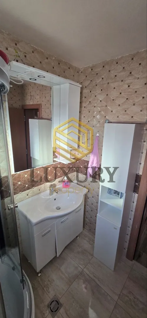 Bathroom with a sink, cabinet, and mirror.