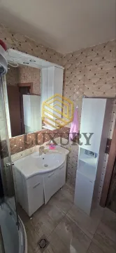 Bathroom with a sink, cabinet, and mirror. - image 9