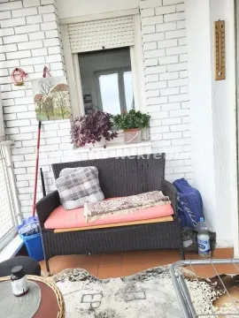 Small furnished balcony with seating furniture and decorative plants. - image 19