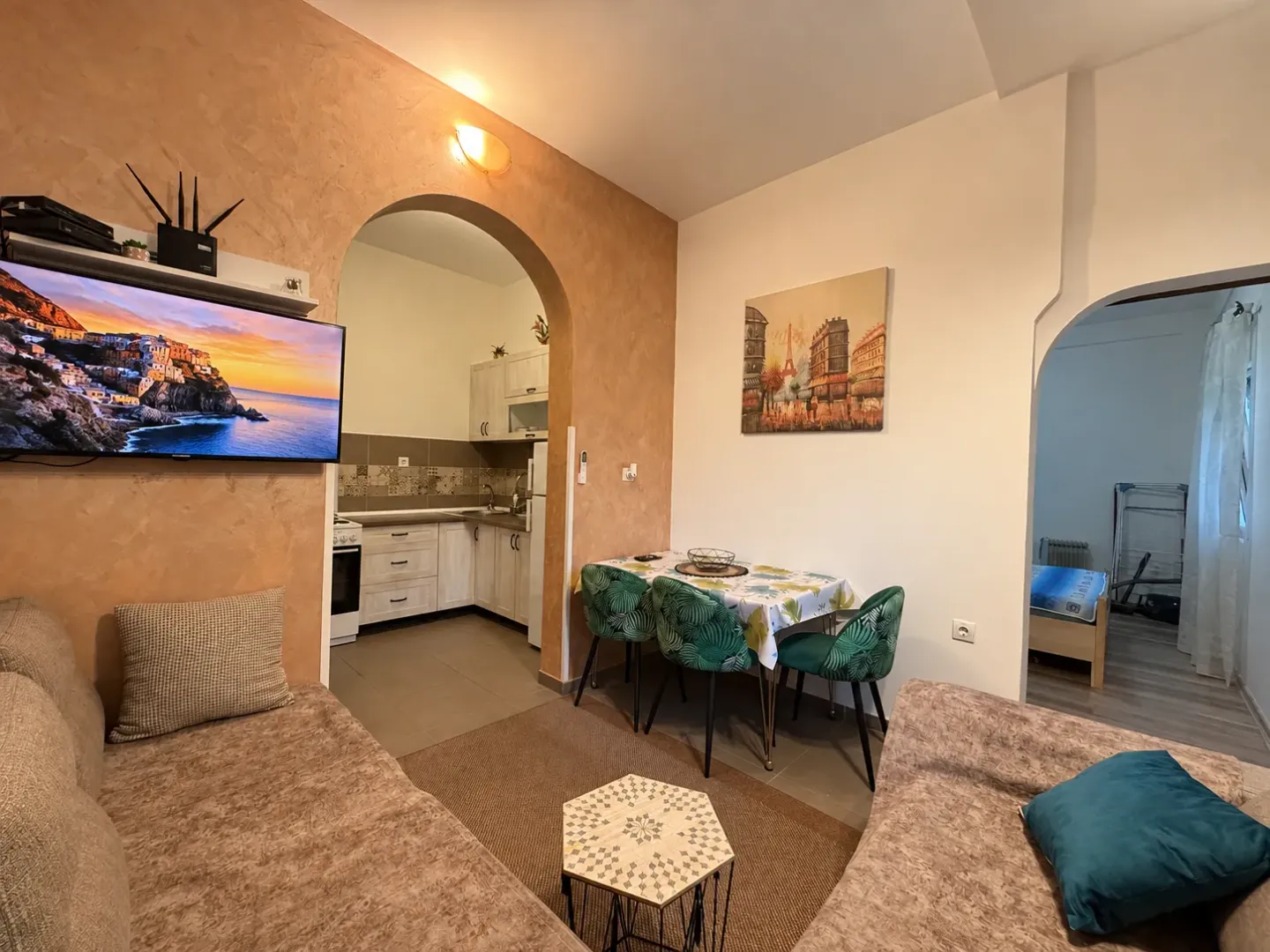 Living room with dining area and view of the kitchen.