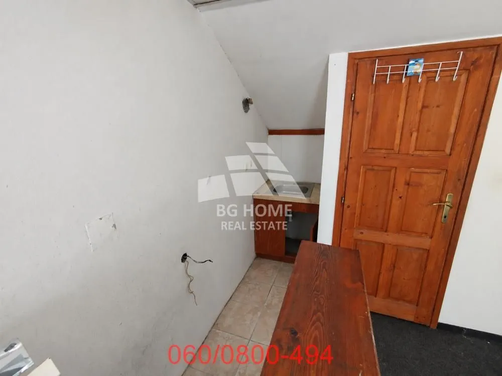 Small kitchen with wooden elements and a sink.