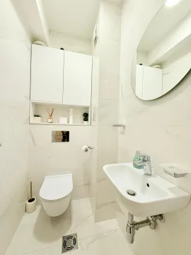 Modern and brightly decorated bathroom with white ceramic tiles. - image 8