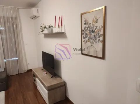 Living room with a TV, media console, and decorative wall painting. - image 9