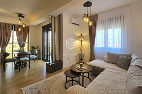 Spacious living room with sofa set, dining area, and access to the terrace. - image 2