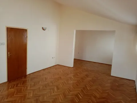 A spacious empty room with parquet flooring. - image 8