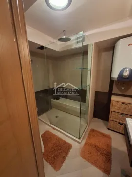 Bathroom with a walk-in shower and built-in elements. - image 7
