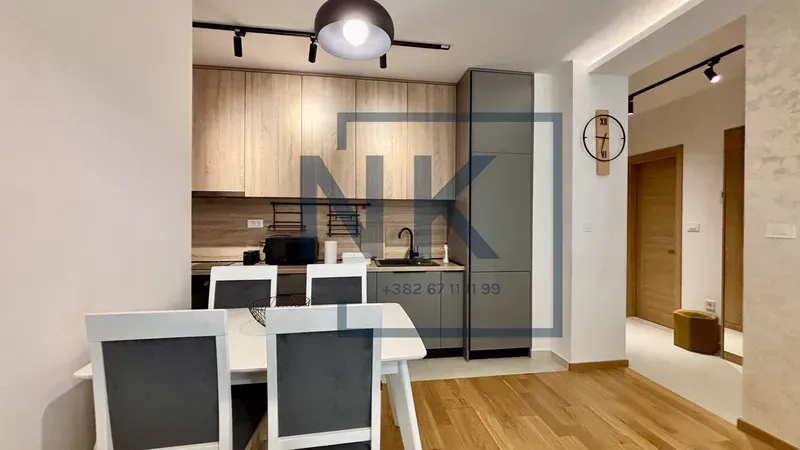 Modern kitchen with dining area and built-in units.