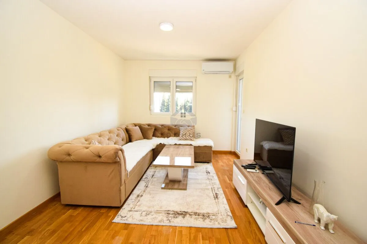 Living room with a sectional sofa, coffee table, and TV.