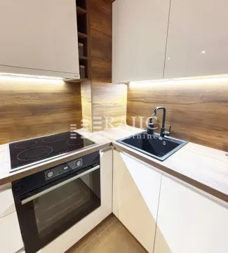 Modern kitchen with built-in hob, oven, and sink. - image 4