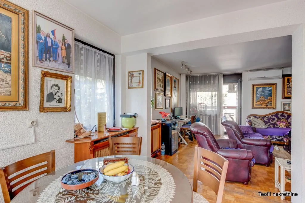 Living room with a dining table and seating furniture.