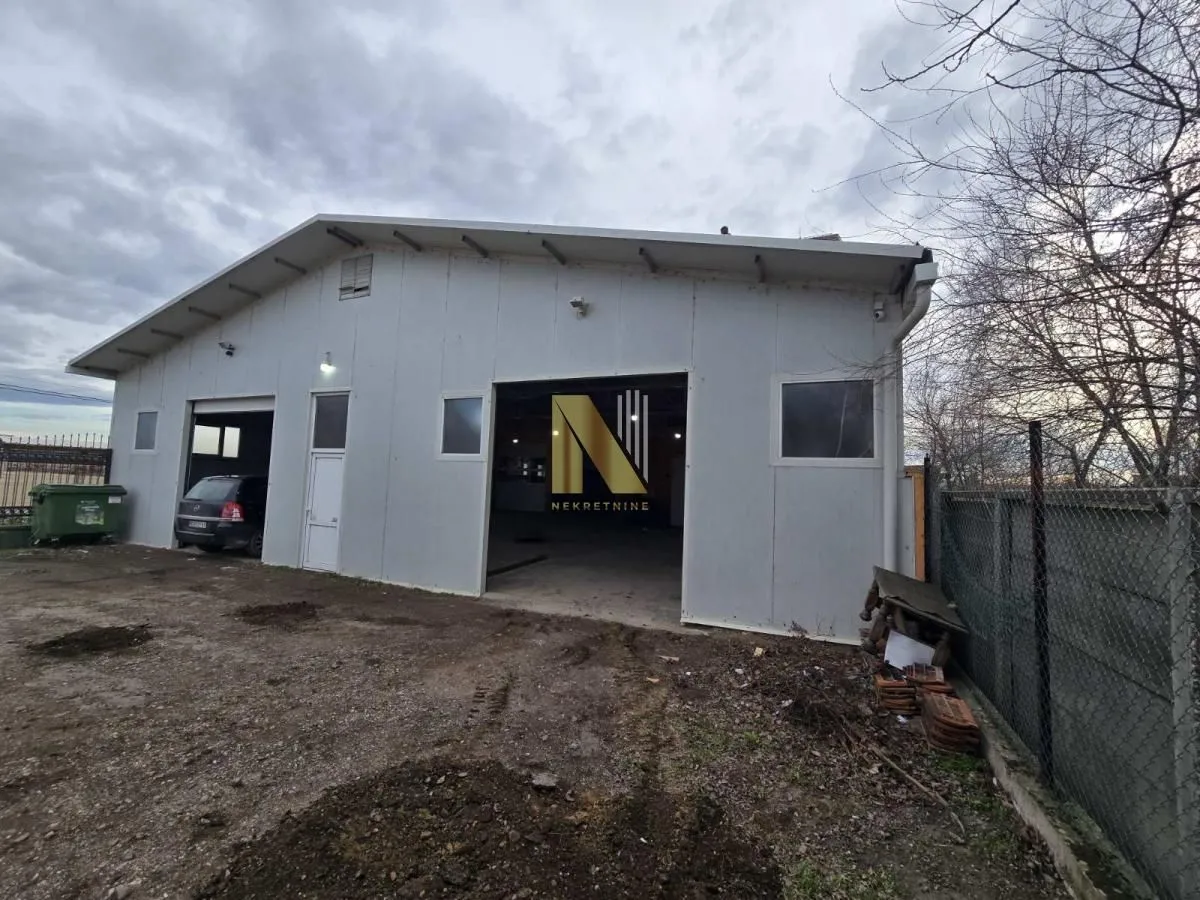 Exterior view of a commercial building with storage space and a yard.