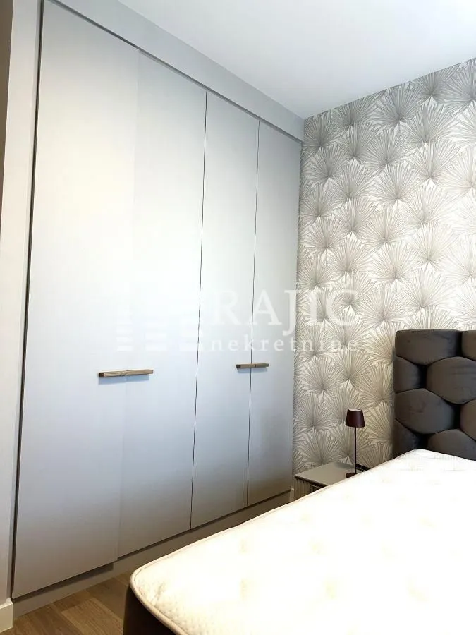 Modern bedroom with a built-in wardrobe and a double bed.