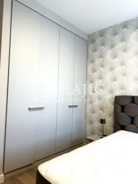 Modern bedroom with a built-in wardrobe and a double bed. - image 9