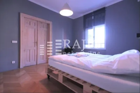 Bedroom with a double bed, wooden doors and parquet flooring. - image 2