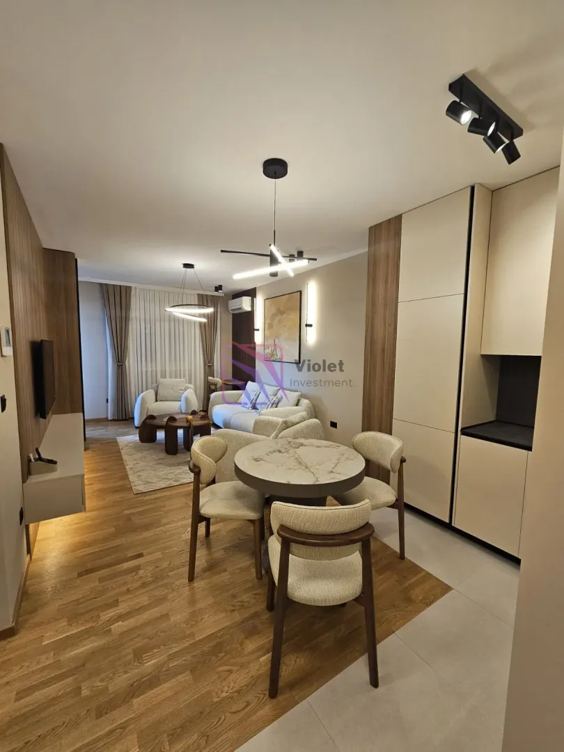 Modern living room with dining area and built-in units.