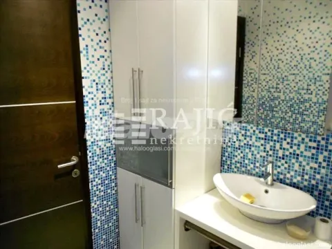 Modern bathroom with a sink and mosaic tiles. - image 5