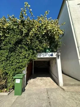 Garage entrance with greenery above. - image 9