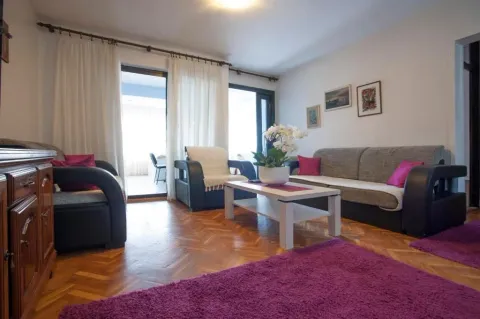 Living room with a sofa set, coffee table, and parquet flooring. - image 2