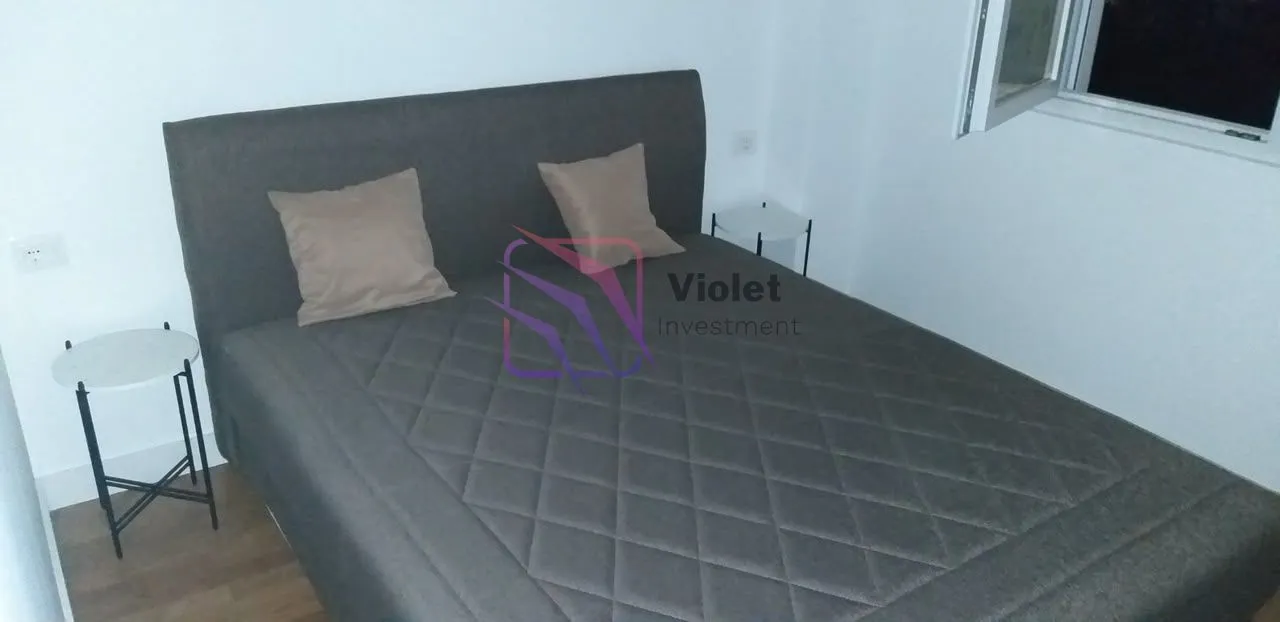 Bedroom with a large double bed and nightstands.