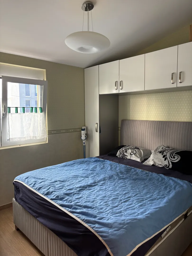 Furnished bedroom with a double bed and fitted wardrobe.