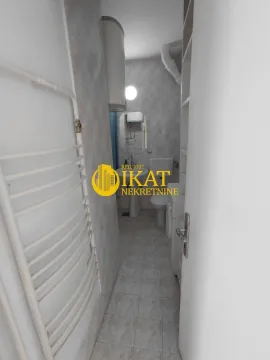View of the bathroom with a sink, toilet, and radiator. - image 2