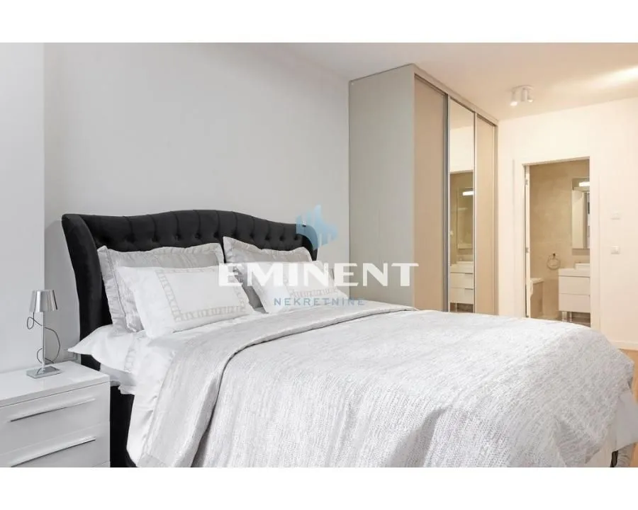 Furnished bedroom with a double bed, wardrobe, and en-suite bathroom.