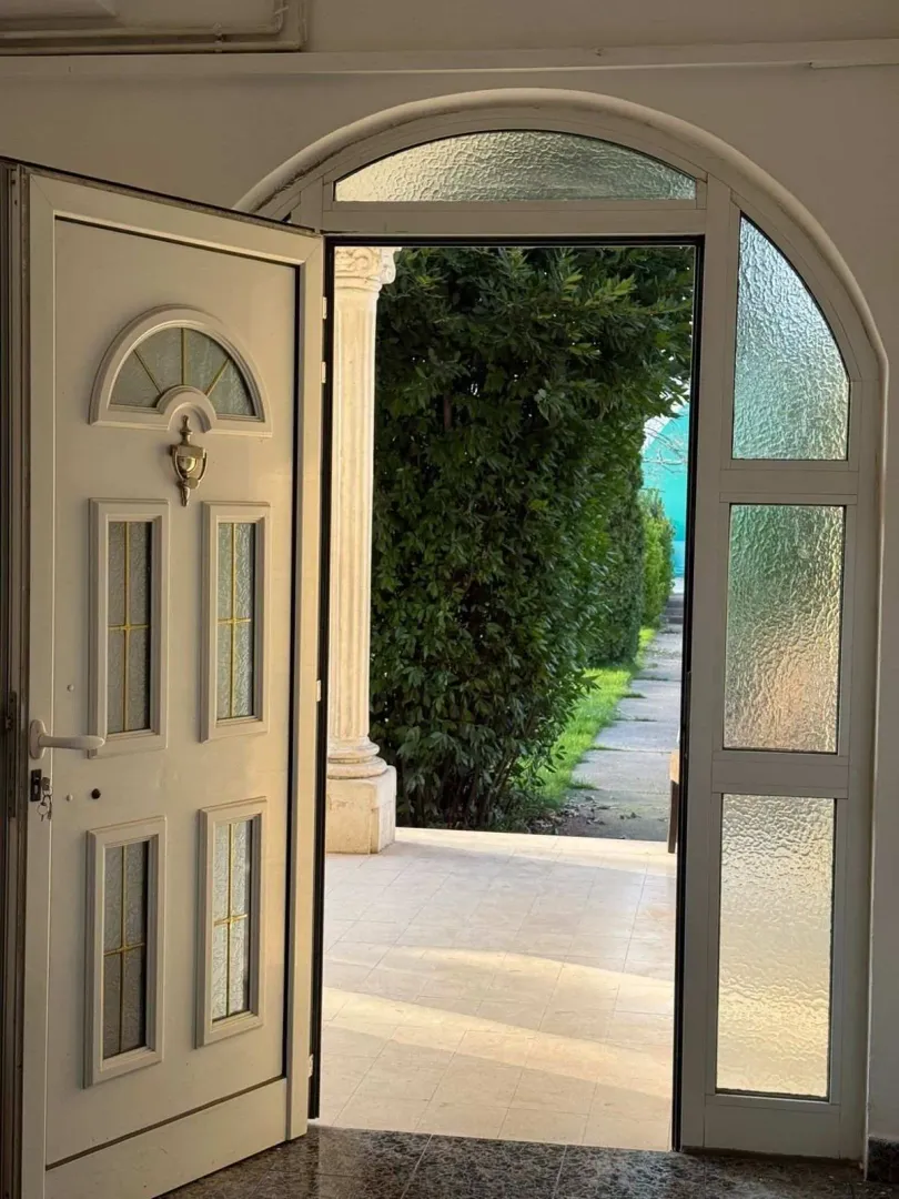 An open front door looking out onto the yard.