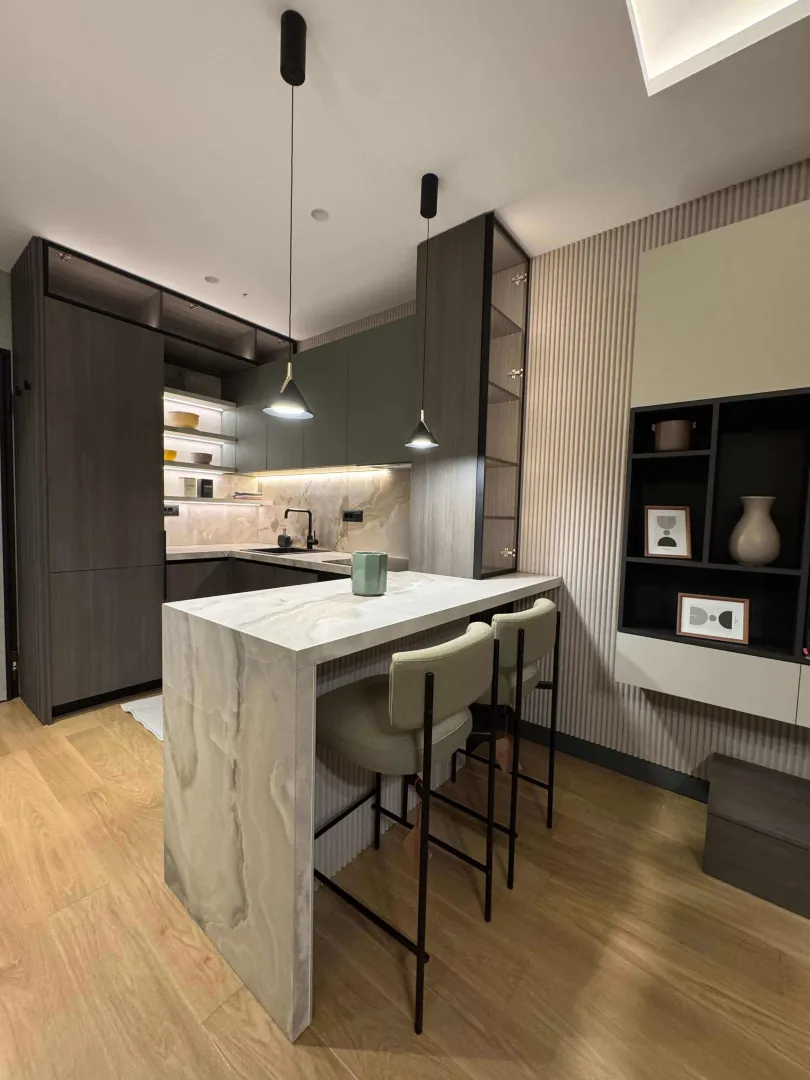 Modern kitchen with a breakfast bar and built-in units.