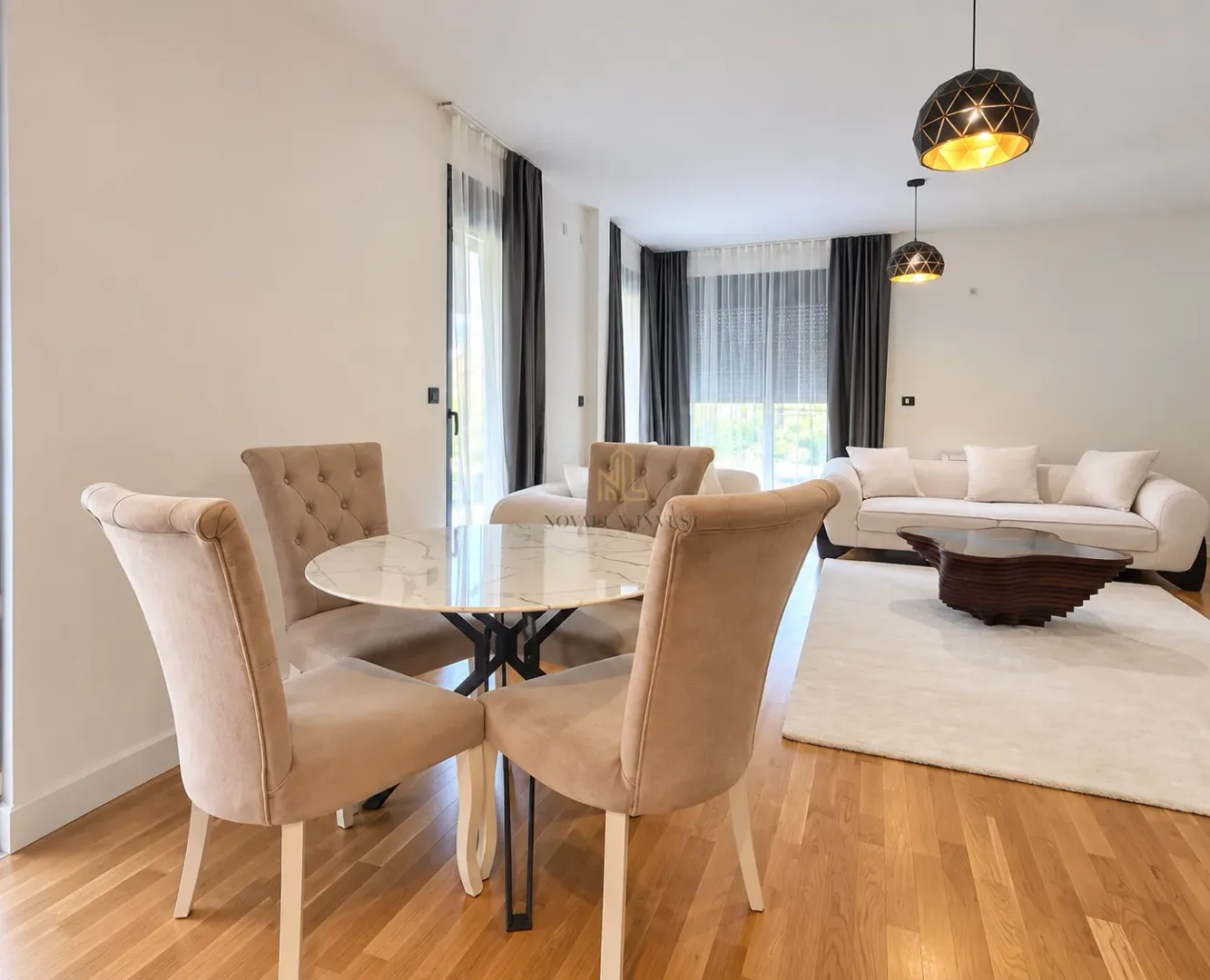 Spacious living room with a dining table and chairs, and a seating sofa set.