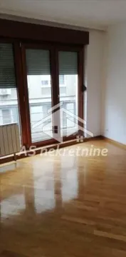 Empty room with hardwood floors and large balcony doors. - image 5