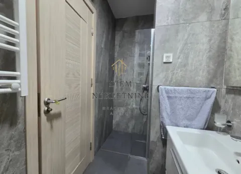 Modern bathroom equipped with a walk-in shower. - image 10