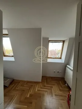 Empty attic room with skylights and parquet flooring. - image 13