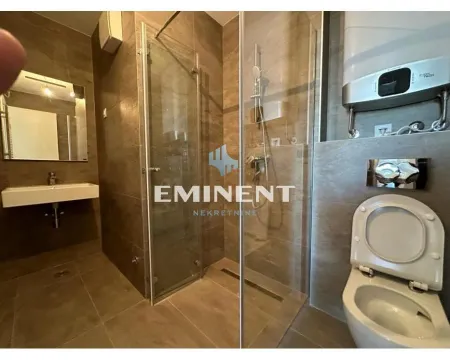 Modern bathroom with a walk-in shower, washbasin, and toilet. - image 14