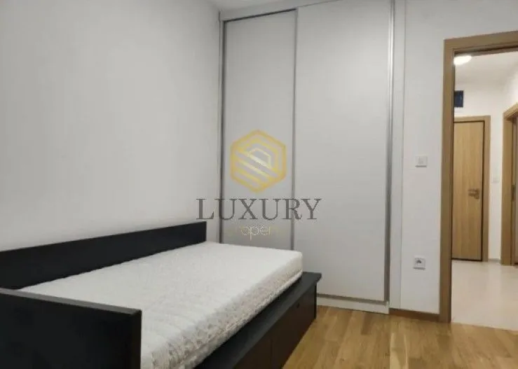 Small bedroom with a bed and a built-in wardrobe.