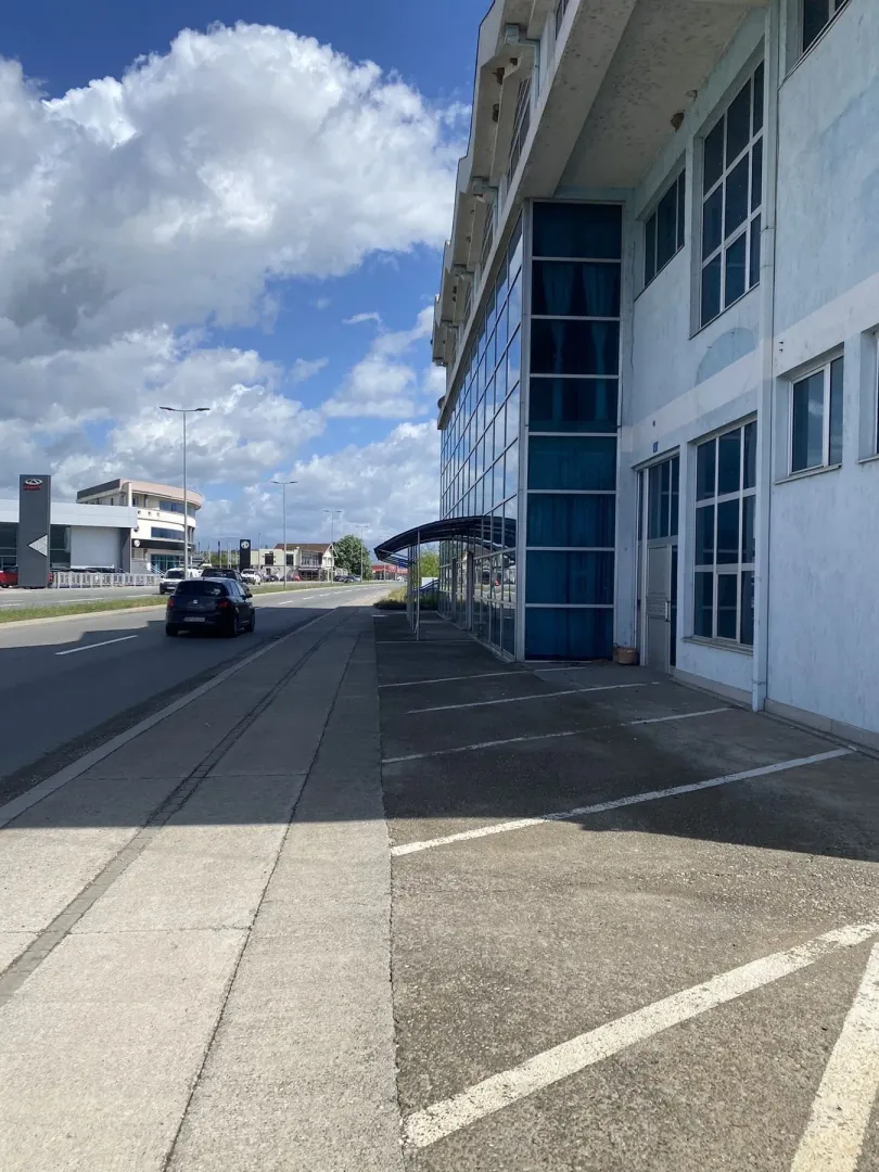 Exterior view of a commercial building with parking spaces.